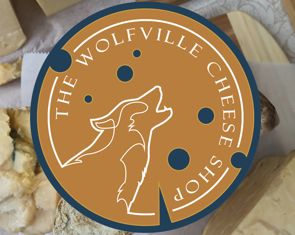 The Wolfville Cheese Shop logo, featuring a cheese wheel and a wolf. 