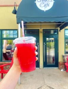 lifting a drink to cheers at Charts Cafe