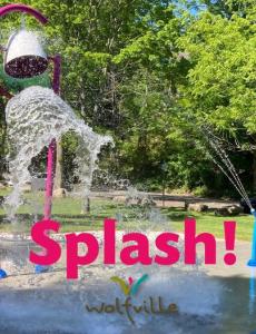 Large bucket dumping water on a Splash Pad