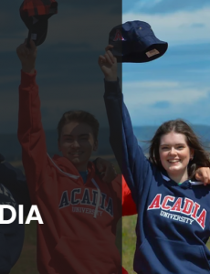 A group of students wearing school branded clothing holding their hats in the air.