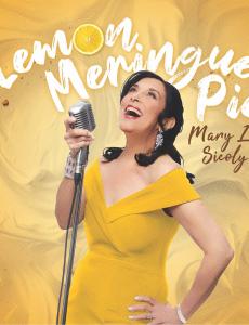 Mary Lou Sicoly: a middle-aged white woman with black hair wearing a yellow dress behind a yellow backdrop that says "Lemon Meringue Pie" poses with a vintage microphone, looking up