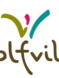Mudley is sitting on the Wolfville logo in a yoga pose